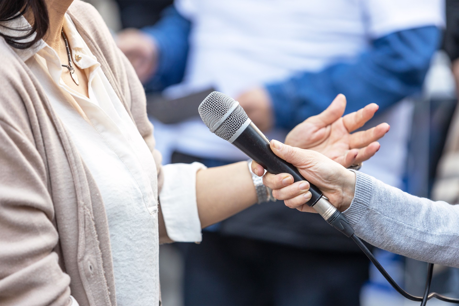 Journalist Holding Microphone Making Media Interview With Female Politician Or Business Woman